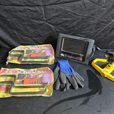 Two brand new deck brackets - a nice sprinkler - work gloves and a Polaroid digital picture frame with outdoor temperature display