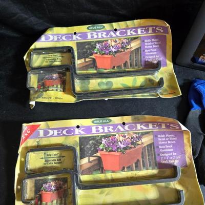 Two brand new deck brackets - a nice sprinkler - work gloves and a Polaroid digital picture frame with outdoor temperature display