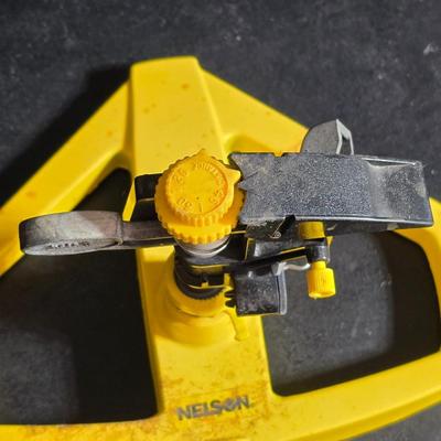 Two brand new deck brackets - a nice sprinkler - work gloves and a Polaroid digital picture frame with outdoor temperature display