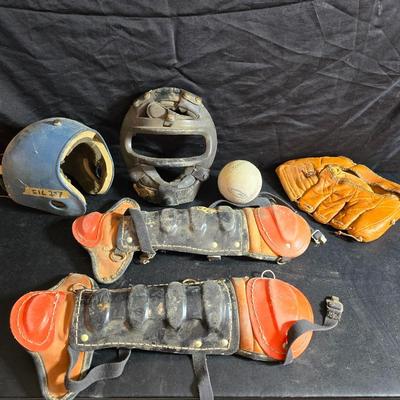 Vintage baseball helmets with pads and a vintage leather glove