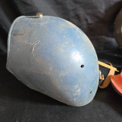 Vintage baseball helmets with pads and a vintage leather glove