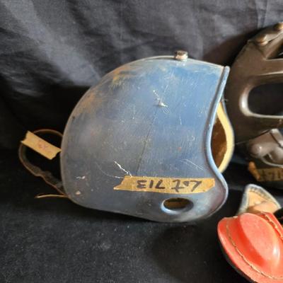 Vintage baseball helmets with pads and a vintage leather glove