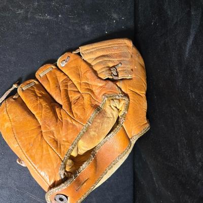 Vintage baseball helmets with pads and a vintage leather glove