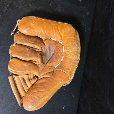 Vintage baseball helmets with pads and a vintage leather glove