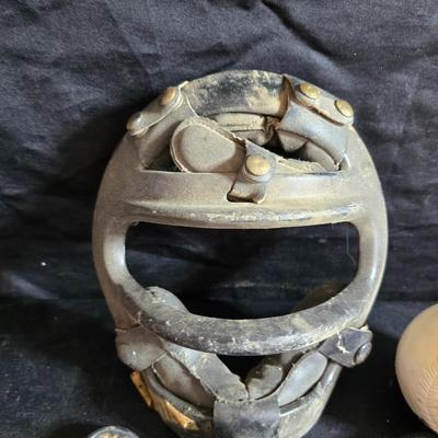 Vintage baseball helmets with pads and a vintage leather glove