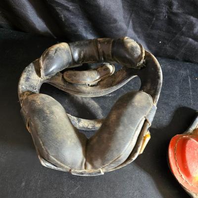 Vintage baseball helmets with pads and a vintage leather glove