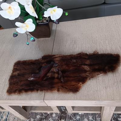 FAUX ORCHID IN CERAMIC POT, CARVED WOODEN SEALS AND AN ANIMAL PELT