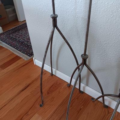 A TRIO OF HAND FORGED FLOOR CANDLE HOLDERS