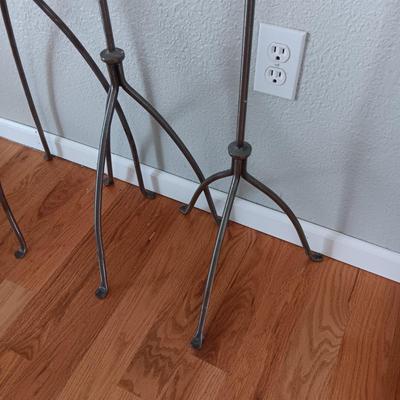 A TRIO OF HAND FORGED FLOOR CANDLE HOLDERS