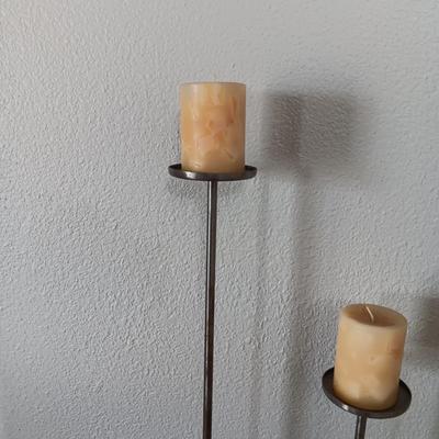 A TRIO OF HAND FORGED FLOOR CANDLE HOLDERS