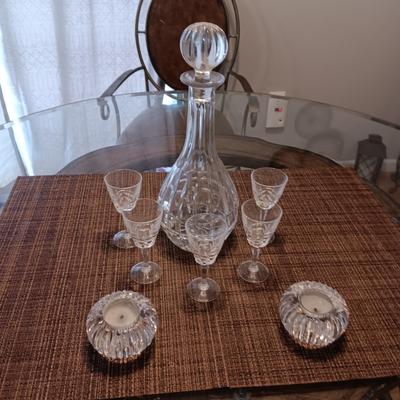 CRYSTAL DECANTER, 5 SMALL STEMMED GLASSES AND CRYSTAL VOTIVE CANDLE HOLDERS
