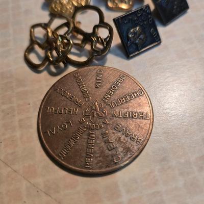 Sale Photo Thumbnail #82: This is a grouping of Scouting Collectibles for cub scouts, boy scouts and girl scouts.  Includes the Oath Challenge Coin, Girl Scout Lapel   Pins and a Cub Scout and Bob Scout Lapel Pins.  Nice collection.