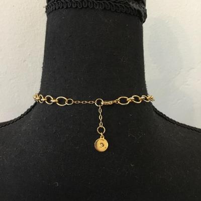 Vince Camuto Gold tone, tassel, white stone necklace, and emerald green rhinestone