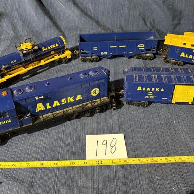 Lionel O Gauge Alaska Railroad model train cars and a diesel