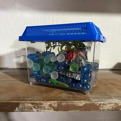 Sale Photo Thumbnail #359: Small fish tank for small gold fish is perfect for kids or beginners looking to get into aquatic pets.  Comes with rocks, fake plant, and a starfish centerpiece.