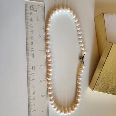 Sale Photo Thumbnail #101: This auction lot is for a Pearl Necklace. This necklace is made with cultured, hand-induced, natural pearls. This is a beautiful set of pearls - just perfect to accompany your little black dress.