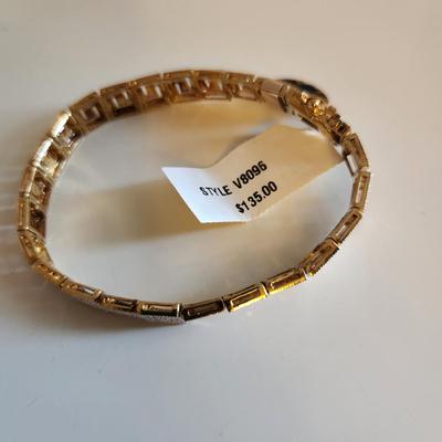 Sale Photo Thumbnail #102: This auction lot is for a Gold-Washed and Sterling Silver Bracelet.  This handsome bracelet has a backside of gold-wash and a front that sports a unique metalic design in sterling silver.  The bracelet is marked 925.  The bracelet is new and still has the