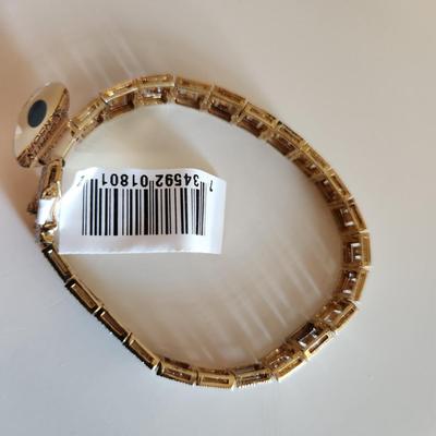 Sale Photo Thumbnail #105: This auction lot is for a Gold-Washed and Sterling Silver Bracelet.  This handsome bracelet has a backside of gold-wash and a front that sports a unique metalic design in sterling silver.  The bracelet is marked 925.  The bracelet is new and still has the