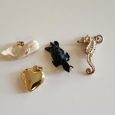 Sale Photo Thumbnail #118: This auction lot is for Four Sweet Charms.  This charms where in the bottom of a small dresser jewelry box in a recent estate. There is a small carved white whale, a carved stone turtle, a sea horse and a gold-tone heart locket in this group.