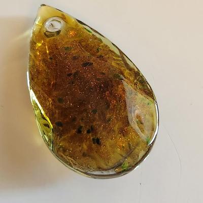 Sale Photo Thumbnail #119: This auction lot is for a Man-made Amber-Like Glass Pendant.  This handsome pendant is drilled and ready for a nice necklace to sport its beauty. See photo for size.