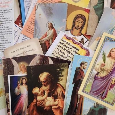 Sale Photo Thumbnail #138: This unique lot is chocked full of Religious Items.  Filled with icons, booklets, pamphlets, medals, scapulars, holy water containers, a plethora of crosses, many holy cards, prayer cards and themed bookmarks. Plus a nice set of praying hands carved from 