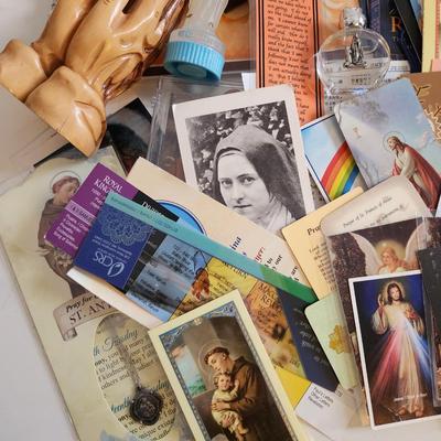 Sale Photo Thumbnail #133: This unique lot is chocked full of Religious Items.  Filled with icons, booklets, pamphlets, medals, scapulars, holy water containers, a plethora of crosses, many holy cards, prayer cards and themed bookmarks. Plus a nice set of praying hands carved from 