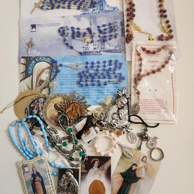 Sale Photo Thumbnail #143: This lot is filled with Rosaries and Relics.  This lot has rosaries and many other types of religious items. There are finger rosaries, religious medals, various metal medallions and ornaments, cross necklace, a chaplet and a selection of many types of ro