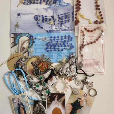 Sale Photo Thumbnail #144: This lot is filled with Rosaries and Relics.  This lot has rosaries and many other types of religious items. There are finger rosaries, religious medals, various metal medallions and ornaments, cross necklace, a chaplet and a selection of many types of ro