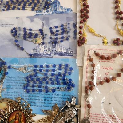 Sale Photo Thumbnail #149: This lot is filled with Rosaries and Relics.  This lot has rosaries and many other types of religious items. There are finger rosaries, religious medals, various metal medallions and ornaments, cross necklace, a chaplet and a selection of many types of ro