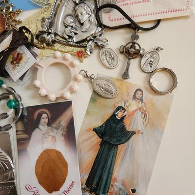 Sale Photo Thumbnail #146: This lot is filled with Rosaries and Relics.  This lot has rosaries and many other types of religious items. There are finger rosaries, religious medals, various metal medallions and ornaments, cross necklace, a chaplet and a selection of many types of ro