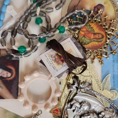 Sale Photo Thumbnail #148: This lot is filled with Rosaries and Relics.  This lot has rosaries and many other types of religious items. There are finger rosaries, religious medals, various metal medallions and ornaments, cross necklace, a chaplet and a selection of many types of ro
