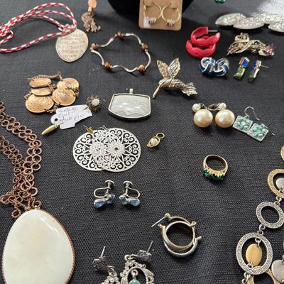Sale Photo Thumbnail #122: Earrings, Necklaces, Pins, and more.
