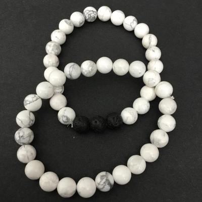 Two pairs of white stone bead, volcanic bead bracelets