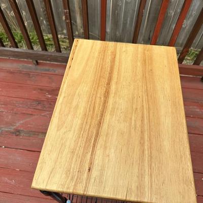 Sale Photo Thumbnail #376: It features two wire shelves and a solid wood (likely maple or butcher block) top for storage and workspace. 
The cart is designed to be functional and efficient, often used in kitchens to keep counters clutter-free. 
It includes four caster wheels which 