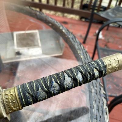 Sale Photo Thumbnail #380: Katana for display or costume purposes.  Blade is metal but does not extend into the hilt as would a combat sword.