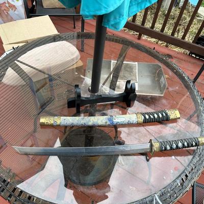 Sale Photo Thumbnail #378: Katana for display or costume purposes.  Blade is metal but does not extend into the hilt as would a combat sword.