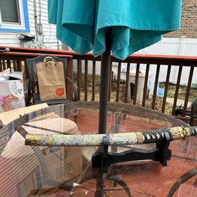 Sale Photo Thumbnail #379: Katana for display or costume purposes.  Blade is metal but does not extend into the hilt as would a combat sword.