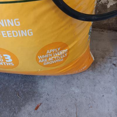 NEW BAG OF WEED AND FEED & A WEED SPRAYER