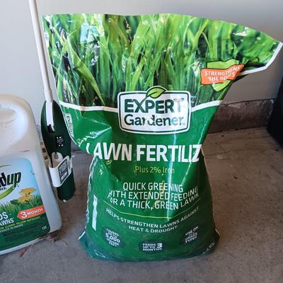 NEW BAG OF LAWN FERTILIZER AND MOSTLY FULL ROUNDUP WEED KILLER