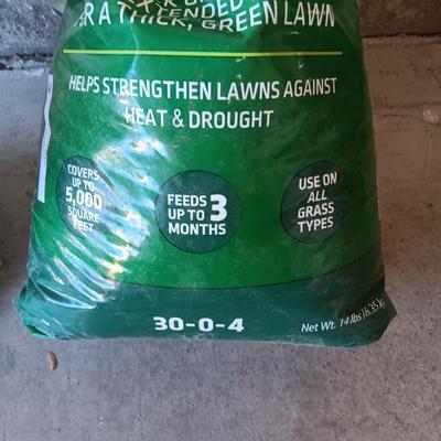 NEW BAG OF LAWN FERTILIZER AND MOSTLY FULL ROUNDUP WEED KILLER