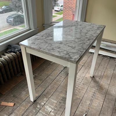 Sale Photo Thumbnail #386: Table has a top that is wrapped to look like granite.  The wrap is pealing along the edges and the table top has some chips in it.