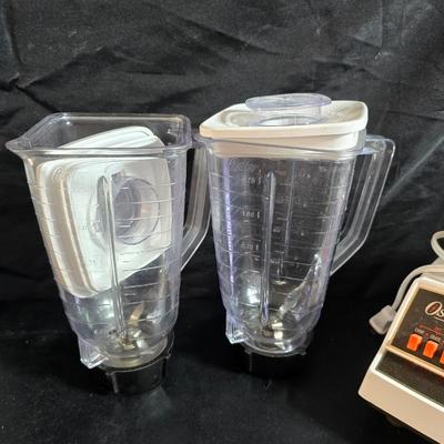 Osterizer pulse matic multi speed blender with extra pitcher and some juice / drink storage containers