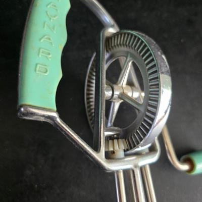 Vintage meat grinder - hand mixer - and an assortment of other kitchen items used on the farm