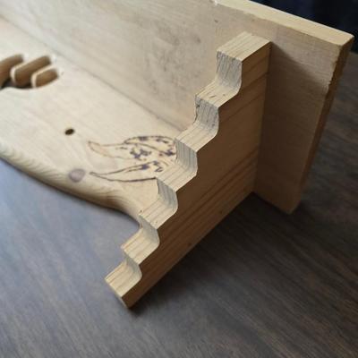Decorative wooden shelf with cactus and two small wooden boxes also wood burned to match
