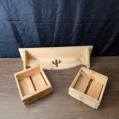 Decorative wooden shelf with cactus and two small wooden boxes also wood burned to match