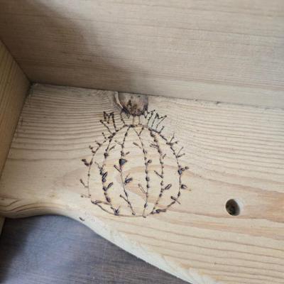 Decorative wooden shelf with cactus and two small wooden boxes also wood burned to match