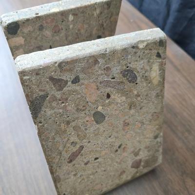 Wedge-shaped fossil stone bookends with a collection of vintage books