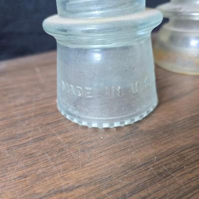 Old glass insulators and three vintage cast iron scale weights