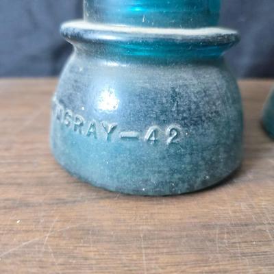 Old glass insulators and three vintage cast iron scale weights