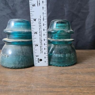 Old glass insulators and three vintage cast iron scale weights